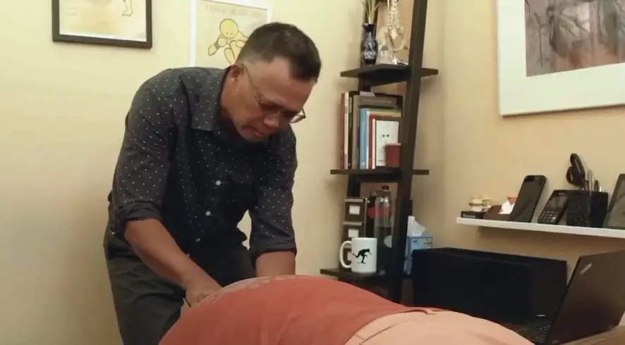 Axis Chiropractic - Dr. Rabbonni Tacusalme Working on a Chiropractic