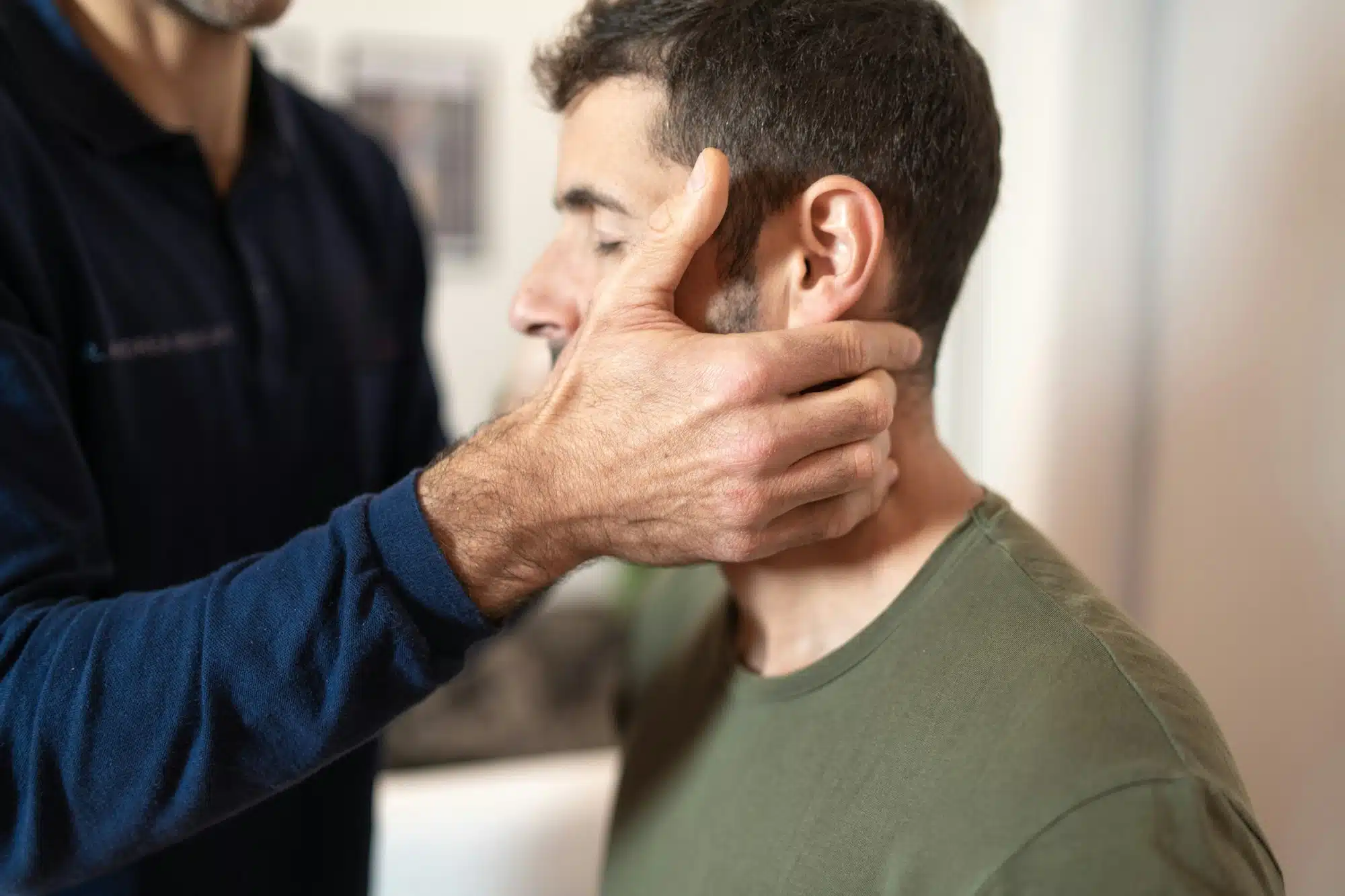 Chiropractor performing neck adjustment for pain relief in San Francisco clinic